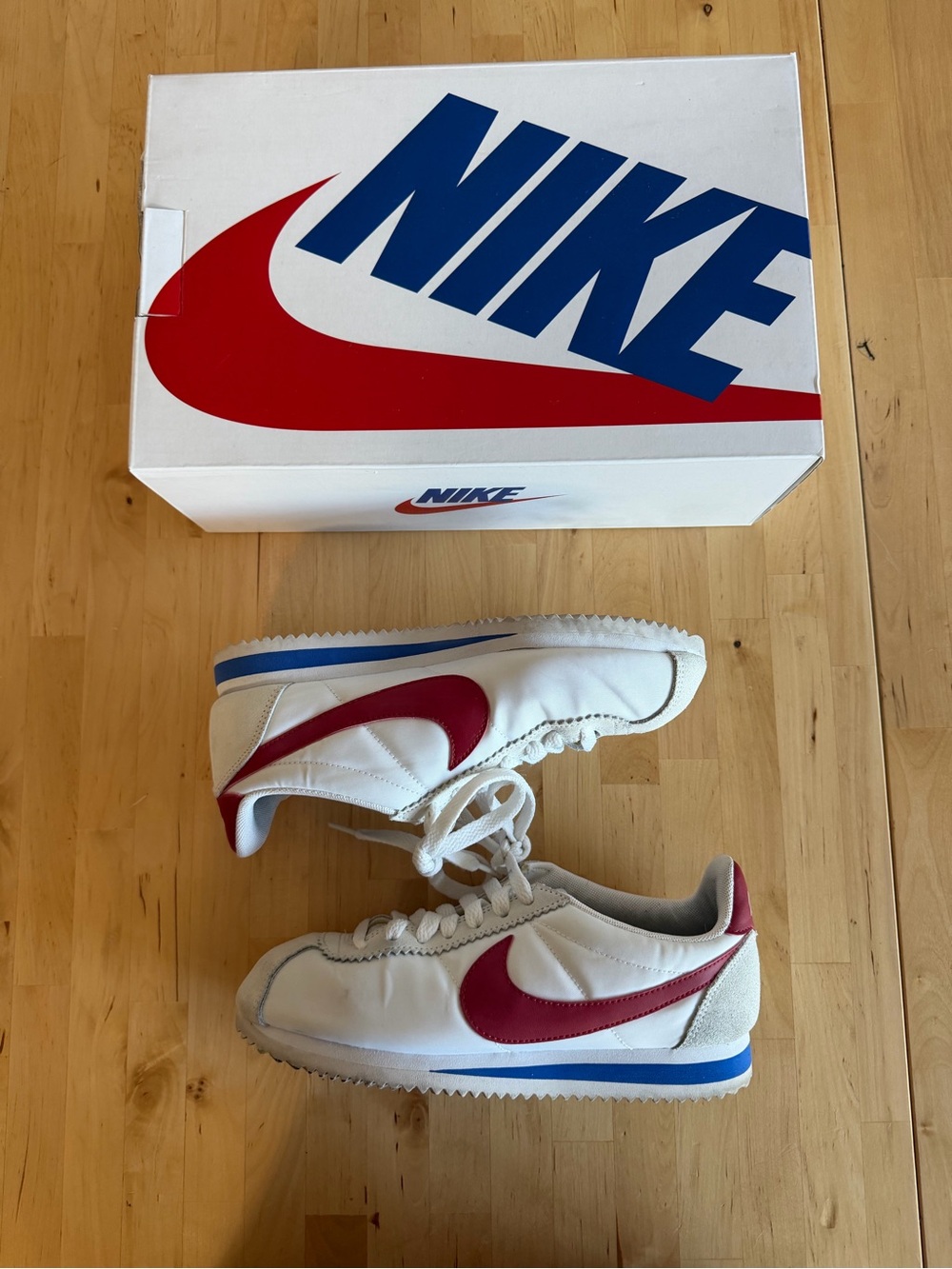 Nike White Sneakers with Red Swoosh and Blue Midsole Accents